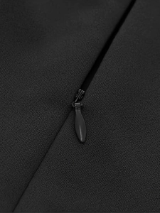 Detail of invisible black zipper closure on French style V-neck summer dress fabric