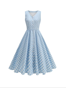 Detail of blue gingham dress featuring V-neckline with white lace trim and decorative buttons
