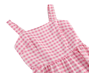 Close-up detail of pink gingham dress featuring square neckline and pleated waist design
