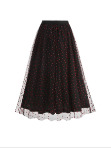 Detailed view of black tulle midi skirt with red heart prints and elastic waist design