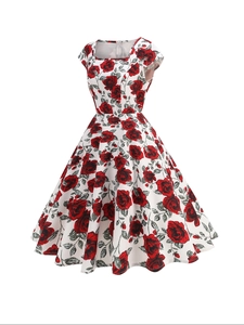Close-up of vintage floral print with red roses on a white square neck dress