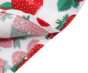 Detailed macro view of strawberry print fabric with clean hem stitching for girls' dress