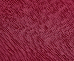Close-up of wine red sleeveless dress fabric with elegant pleated texture detail
