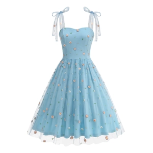 Detail of light blue mesh dress featuring colorful daisy embroidery and bow straps