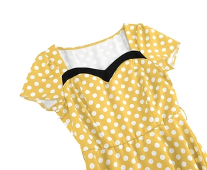 Detail of vintage yellow polka dot dress with unique black heart-shaped neckline