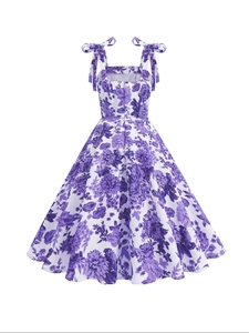 Detail of purple floral dress with adjustable bow shoulder straps and a smocked back