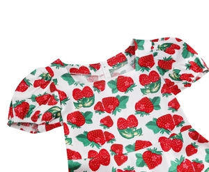 Detail view showing square neckline and strawberry print on girls' cotton dress