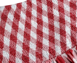 Détail du tissu vichy rouge et blanc avec smocks élastiques et texture plissée douce
