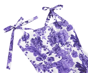 Detail of adjustable bow shoulder straps and purple floral print on vintage dress