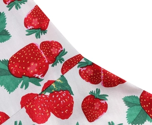 Close-up of strawberry print on high-quality white fabric for girl's summer dress