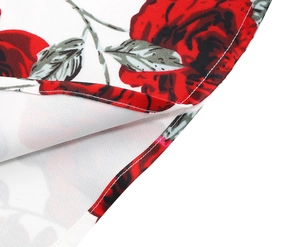 Close-up of elegant red rose print and precise double-stitched hem on the floral dress