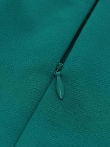 Macro shot of dark green v-neck dress featuring a seamless concealed zipper detail