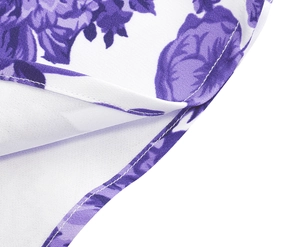 Close-up of vintage purple floral print on white fabric with clean hemline stitching