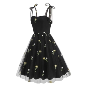 Detail of yellow daisy embroidery on black mesh strap dress with shoulder ties