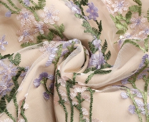 Detail of floral embroidery on mesh fabric for a vintage elegant evening dress