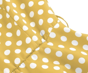 Detailed view of yellow vintage dress featuring white polka dots and stitched pleat details