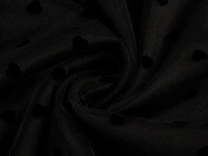 Detail of black polka dot mesh fabric with velvet heart patterns for A-line skirts