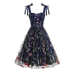 Close-up of floral embroidery on navy mesh dress with elegant ribbon bow straps