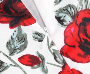 Detail of hidden zipper on white fabric with red rose floral print and fine stitching