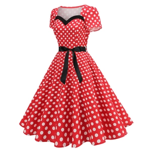 Detail of red polka dot vintage dress featuring sweetheart neckline and black bow belt