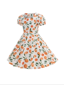 Detailed close-up of a white girl's summer dress featuring fresh orange and citrus leaf prints