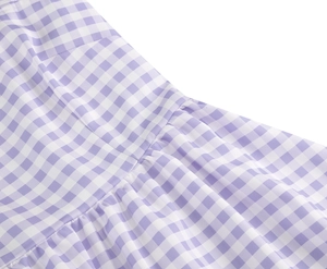 Close-up of pink gingham fabric texture and precise stitching on the long sundress