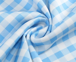 Detailed close-up of blue and white gingham fabric texture for French style dresses