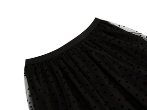 Detailed close-up of black mesh midi skirt featuring velvet heart pattern and elastic waistband