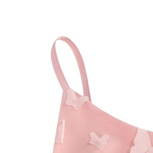 Detail of pink spaghetti strap with 3D butterfly appliqué and silver glitter accents