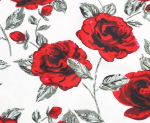 Detail shot of red rose and grey leaf floral print on white summer dress fabric