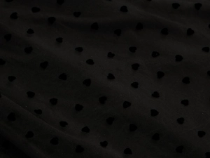 Detail of black polka dot mesh fabric with velvet heart embroidery for midi skirt