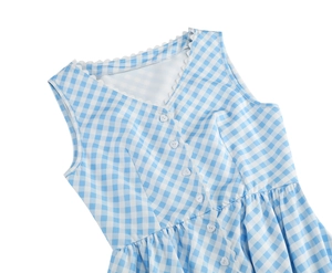 Detail of blue gingham dress featuring white heart buttons and scalloped V-neckline trim