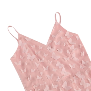 Detailed view of pink dress with 3D butterfly appliques and V-neckline strap design