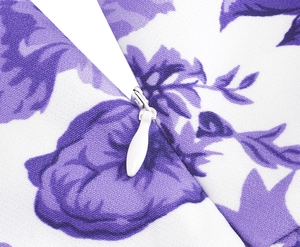 Close-up of invisible zipper and purple floral print on vintage strap dress fabric