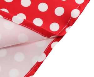 Detailed macro view of red and white polka dot fabric with high-quality white stitching