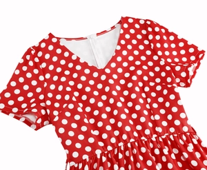 Vista dettagliata dello scollo a V e dei pois bianchi sull'abito vintage rosso acceso