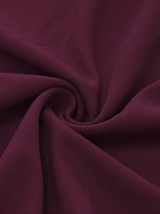Detail of burgundy chiffon fabric with soft matte texture and elegant draping quality