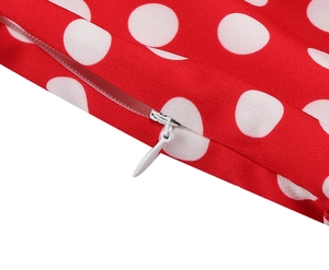Detailed macro view of red fabric with white polka dots and a hidden zipper closure