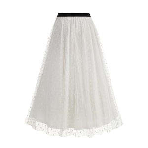 Detailed view of layered white mesh tulle skirt with heart patterns and black elastic waistband