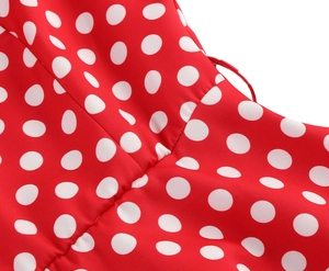 Detail shot of red polka dot vintage dress showing waist pleats and stitching craftsmanship