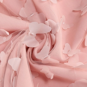 Detail of pink mesh fabric featuring delicate 3D butterfly appliques for elegant dresses