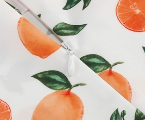 Detailed macro view of high-quality white invisible zipper on girls fruit print dress