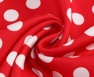 Detailed macro view showing the texture of red fabric with white polka dot patterns
