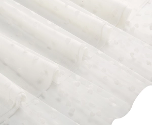 Detailed macro view of white swiss dot mesh fabric with heart-shaped velvet dots