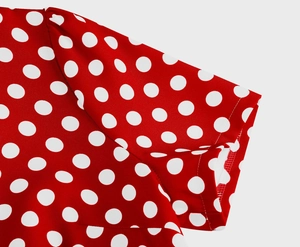 Vista macro dettagliata di pois bianchi su tessuto rosso con trama di cuciture fini