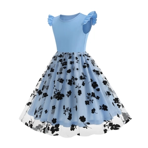 Detail of blue girl's dress showing mesh layer with black floral flocking pattern