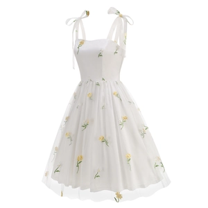 Detail of yellow flower embroidery on white mesh strap dress with lace-up shoulders