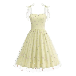 Close-up of yellow mesh dress featuring delicate daisy embroidery and bow straps