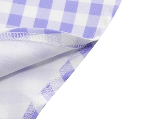 Macro detail of high-quality overlock stitching on purple and white gingham fabric
