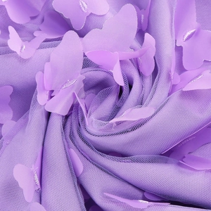 Macro shot of purple mesh fabric featuring 3D butterfly appliques and intricate textures